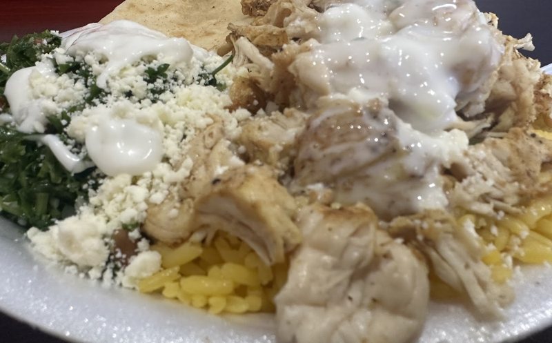 Chicken platter with yellow rice, tabouli, feta, tzatziki and pita